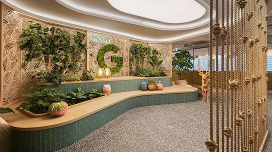 An office space with the “G” logo in green and various plants.