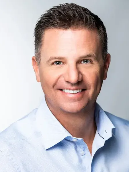 Man smiling at camera in button down shirt
