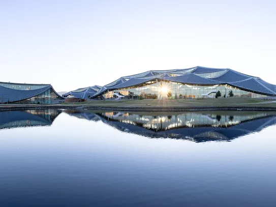 Bay View campus and its reflection in adjacent pond.